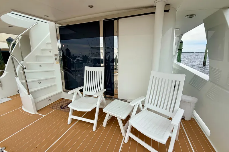Southern Lady Yacht Photos Pics Deck of 2002 Cheoy Lee 72 Yacht with white chairs and ocean view.