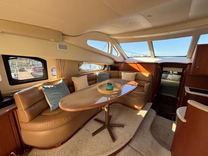 Kong Yacht Photos Pics Luxurious interior of 2005 Silverton 38 Sport Bridge yacht with leather seating and elegant table.