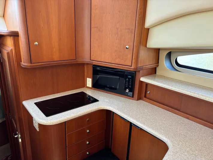 Kong Yacht Photos Pics 2005 Silverton 38 Sport Bridge yacht kitchen with wood cabinetry and modern appliances.