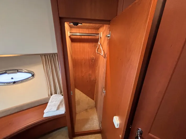 Kong Yacht Photos Pics 2005 Silverton 38 Sport Bridge interior closet with wooden finish and hangers.