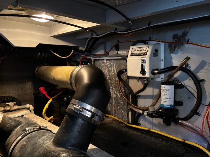 Kong Yacht Photos Pics Engine room of 2005 Silverton 38 Sport Bridge with visible pipes and equipment.