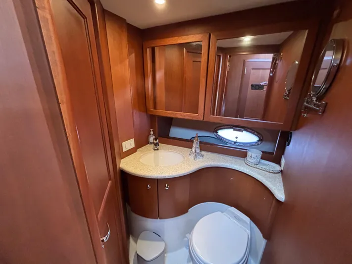 Kong Yacht Photos Pics Luxurious bathroom in 2005 Silverton 38 Sport Bridge yacht with wood cabinetry and modern fixtures.