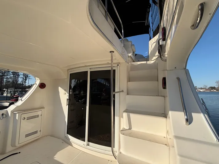 Kong Yacht Photos Pics 2005 Silverton 38 Sport Bridge yacht interior with stairs and sliding glass door.