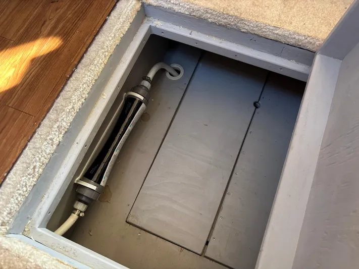 Kong Yacht Photos Pics Access hatch on 2005 Silverton 38 Sport Bridge, revealing interior compartment and piping.