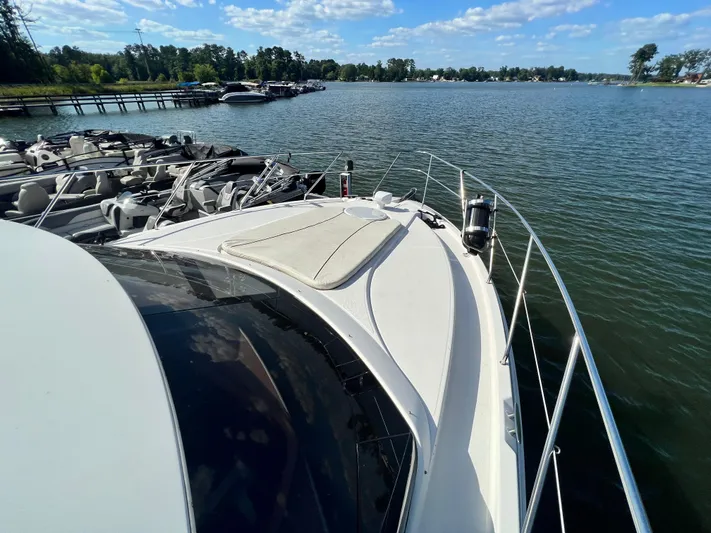 Kong Yacht Photos Pics 2005 Silverton 38 Sport Bridge yacht docked on a sunny lake with clear skies.