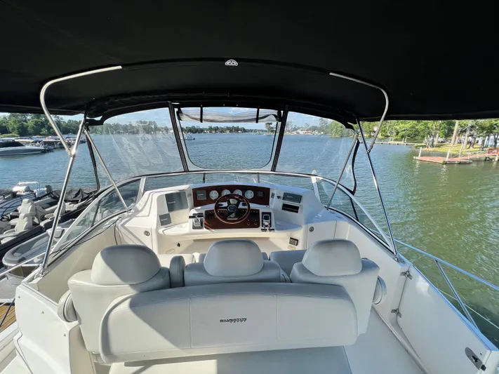 Kong Yacht Photos Pics 2005 Silverton 38 Sport Bridge yacht helm with lake view and canopy.