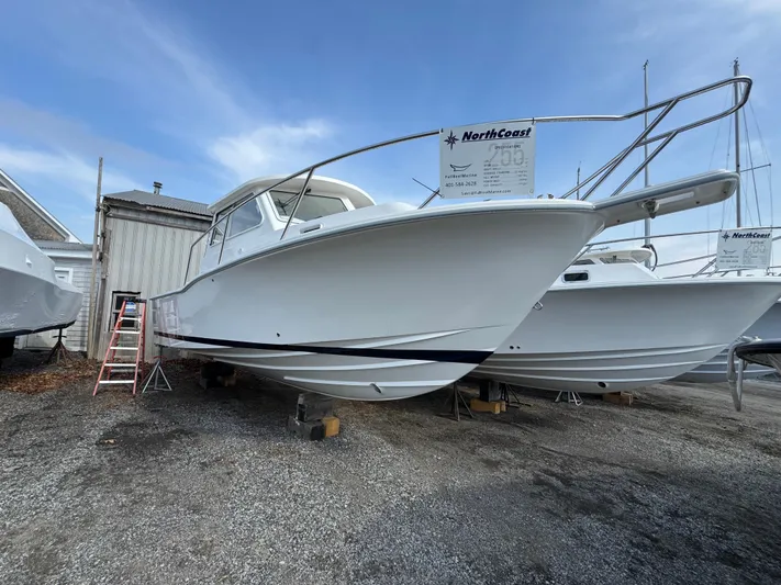  Yacht Photos Pics 2025 NorthCoast 255 HT boat on display, elevated on blocks, with a clear blue sky background.