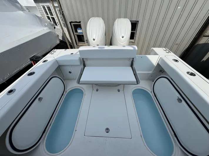  Yacht Photos Pics 2025 NorthCoast 255 HT boat deck with seating and storage compartments.