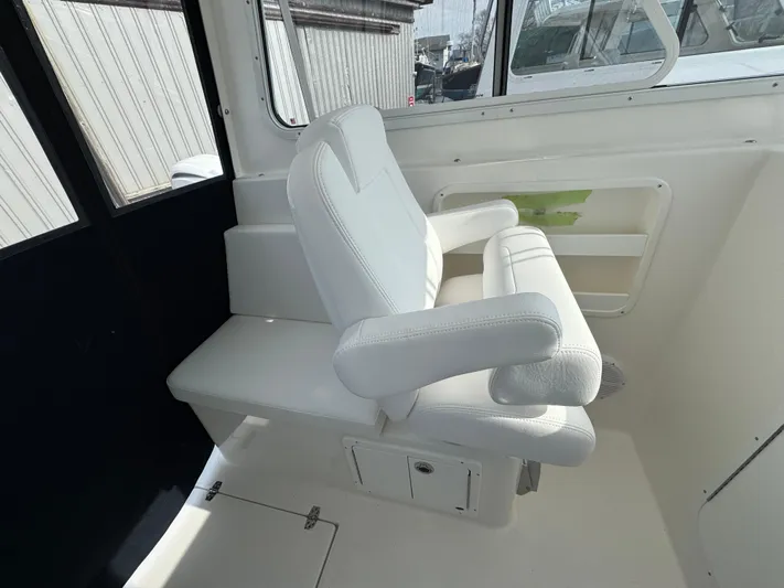  Yacht Photos Pics 2025 NorthCoast 255 HT boat interior with white seating and window view.
