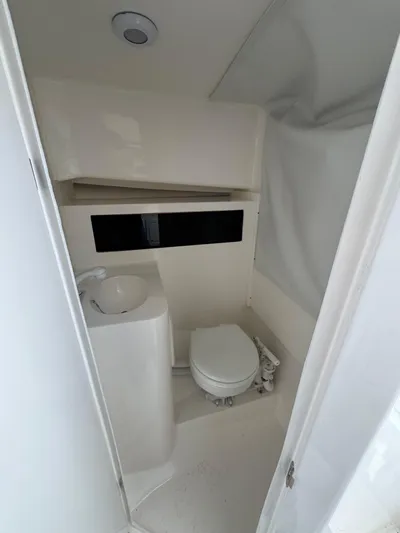  Yacht Photos Pics 2025 NorthCoast 255 HT boat bathroom with compact toilet and sink.