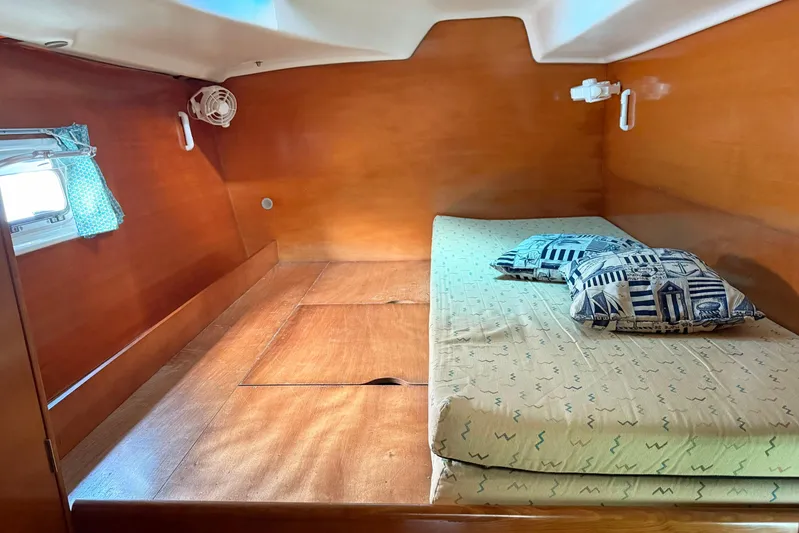  Yacht Photos Pics Cozy cabin interior of 2003 Lagoon 380 catamaran with wooden finish and patterned cushions.