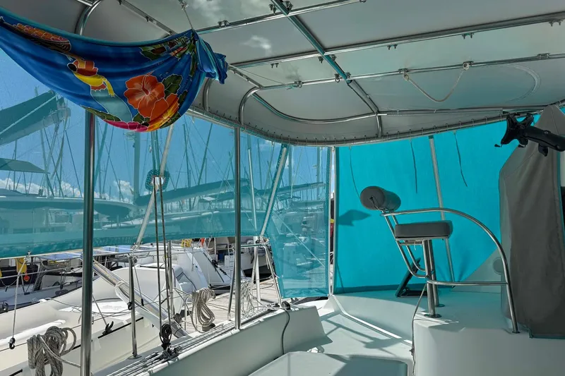  Yacht Photos Pics Interior view of a 2003 Lagoon 380 catamaran with vibrant blue and floral decor.