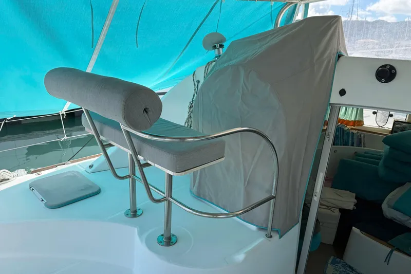  Yacht Photos Pics 2003 Lagoon 380 catamaran interior with cushioned seating and covered helm station.