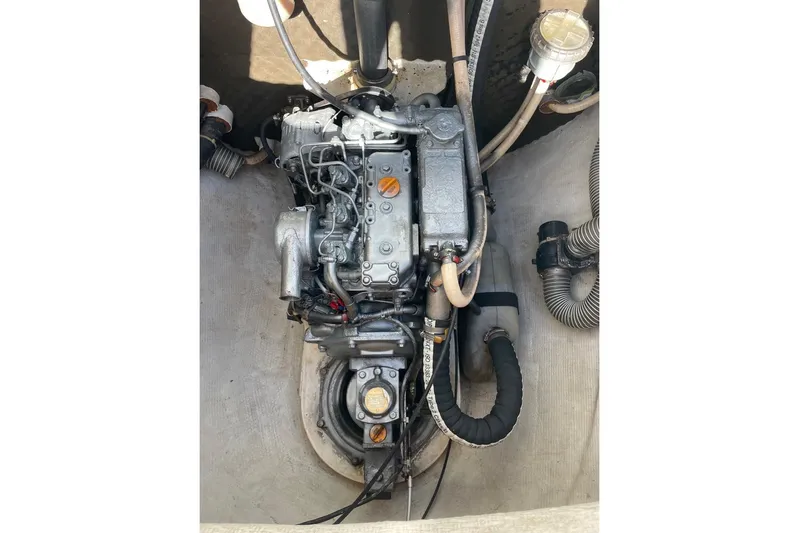  Yacht Photos Pics Engine compartment of a 2003 Lagoon 380 catamaran, showcasing mechanical components and hoses.