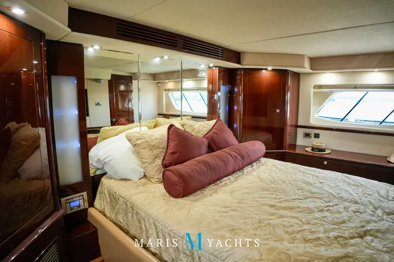 Man O War Yacht Photos Pics Luxurious bedroom interior of 2009 Sea Ray 55 Sundancer yacht with elegant bedding and wood finishes.