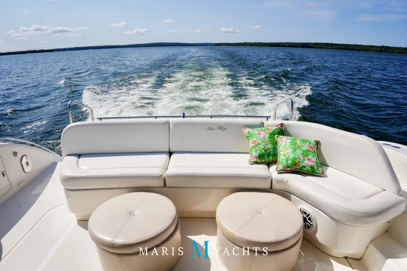 Man O War Yacht Photos Pics 2009 Sea Ray 55 Sundancer yacht with white seating and tropical cushions on open water.