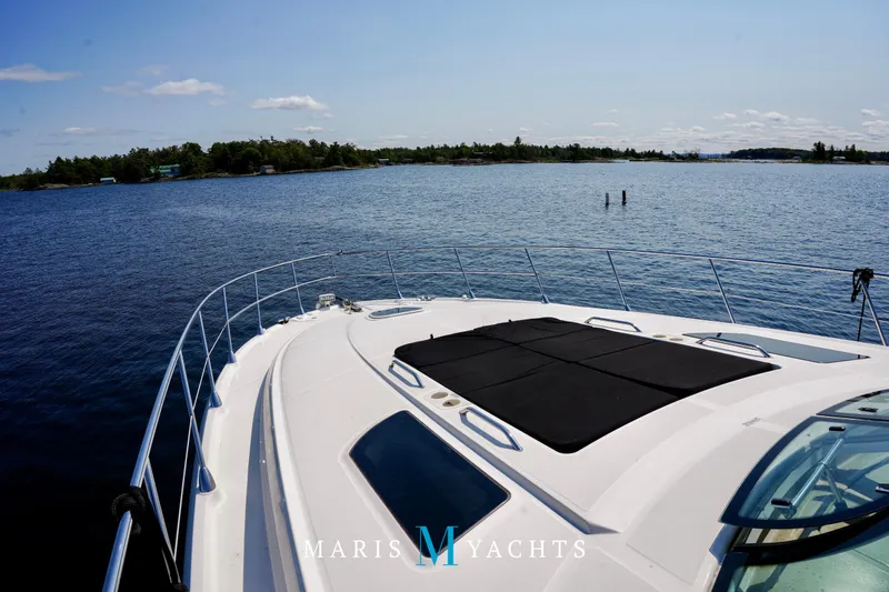 Man O War Yacht Photos Pics 2009 Sea Ray 55 Sundancer yacht cruising on a serene lake with clear skies.