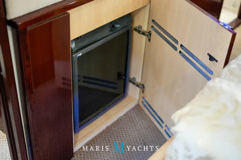 Man O War Yacht Photos Pics Open cabinet with mini fridge on 2009 Sea Ray 55 Sundancer yacht interior.
