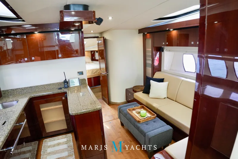 Man O War Yacht Photos Pics Luxurious interior of 2009 Sea Ray 55 Sundancer yacht with modern kitchen and seating area.