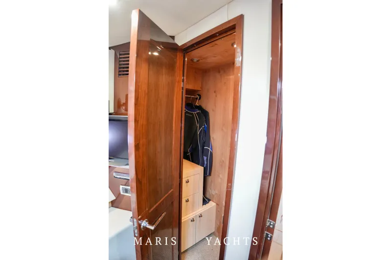 Man O War Yacht Photos Pics Wooden closet interior on 2009 Sea Ray 55 Sundancer yacht, featuring hanging space and drawers.