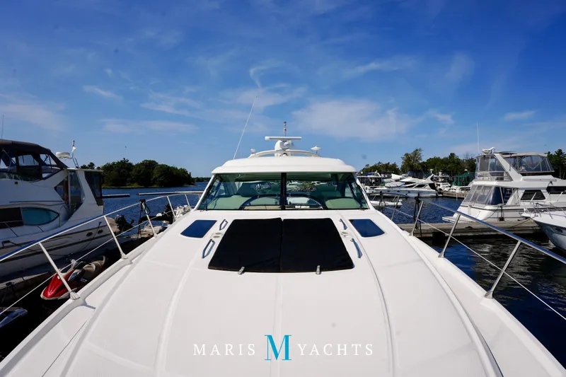 Man O War Yacht Photos Pics 2009 Sea Ray 55 Sundancer yacht docked at marina under clear blue sky.