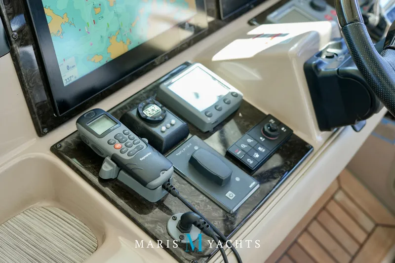 Man O War Yacht Photos Pics Control panel of 2009 Sea Ray 55 Sundancer yacht with navigation equipment and steering wheel.