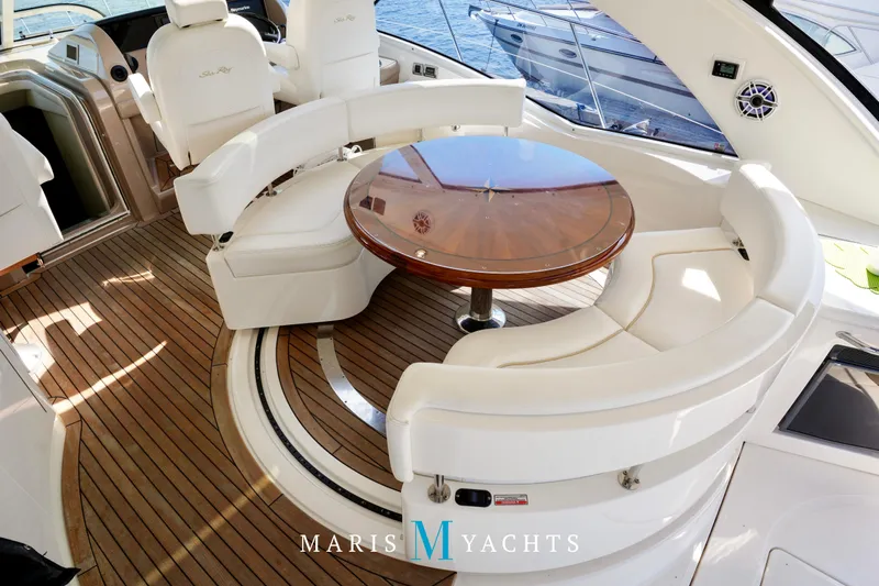 Man O War Yacht Photos Pics Luxurious 2009 Sea Ray 55 Sundancer yacht interior with elegant seating and wooden table.
