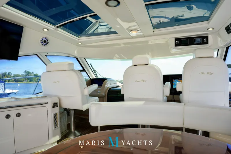 Man O War Yacht Photos Pics Luxurious interior of 2009 Sea Ray 55 Sundancer yacht with white seating and panoramic windows.