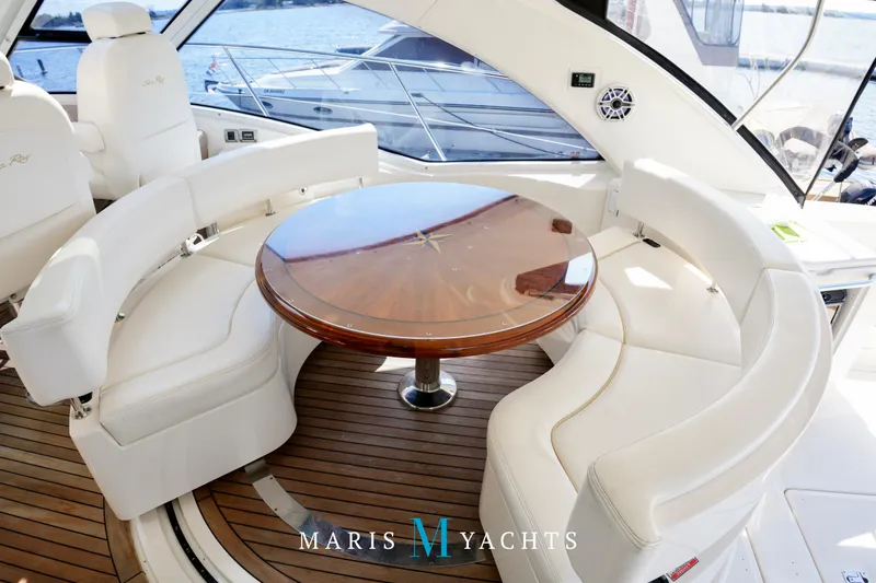 Man O War Yacht Photos Pics Luxurious 2009 Sea Ray 55 Sundancer yacht interior with elegant seating and wooden table.