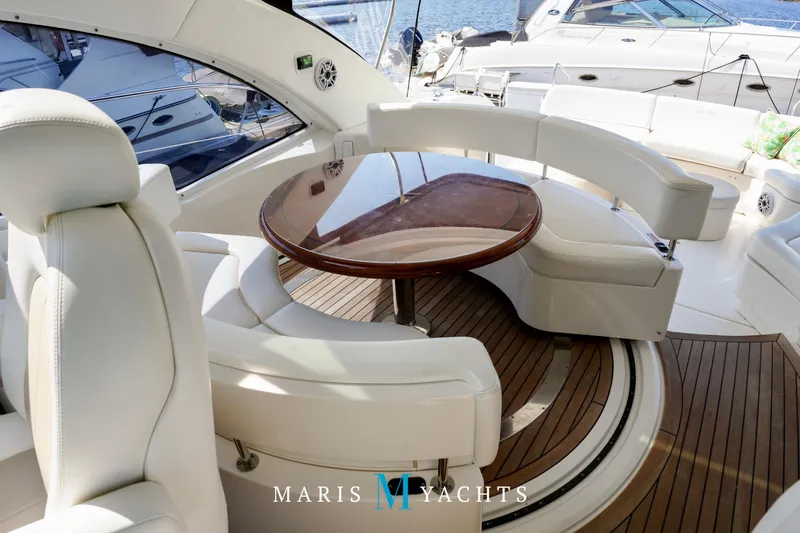 Man O War Yacht Photos Pics Luxurious 2009 Sea Ray 55 Sundancer yacht interior with elegant seating and wooden table.