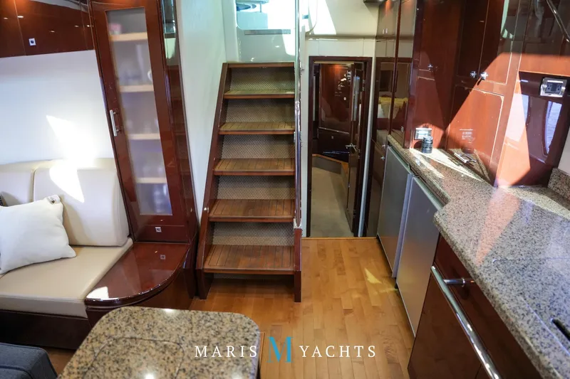 Man O War Yacht Photos Pics Luxurious interior of 2009 Sea Ray 55 Sundancer yacht with wooden stairs and modern kitchen.
