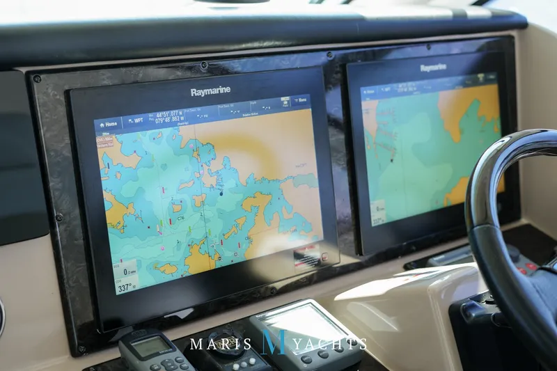 Man O War Yacht Photos Pics Navigation screens on 2009 Sea Ray 55 Sundancer yacht dashboard, displaying marine maps.