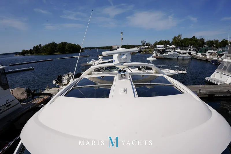 Man O War Yacht Photos Pics 2009 Sea Ray 55 Sundancer yacht docked at marina under clear blue sky.