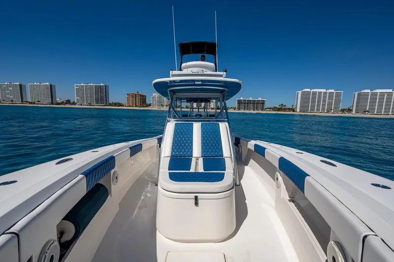  Yacht Photos Pics Front Runner 39 boat, 2020 model, cruising on clear blue water with city skyline backdrop.