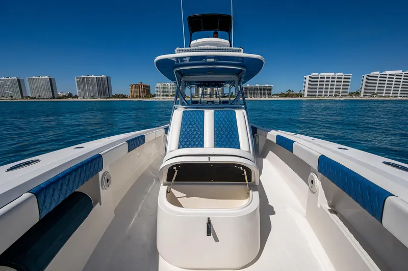 Yacht Photos Pics 2020 Front Runner 39 boat with blue accents, docked near waterfront buildings.