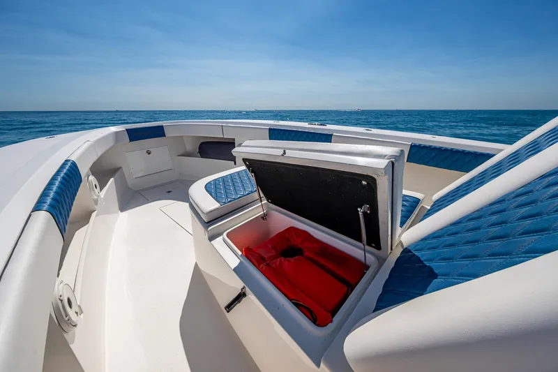  Yacht Photos Pics Front Runner 39 boat interior with open storage compartment, blue seating, ocean view, 2020 model.