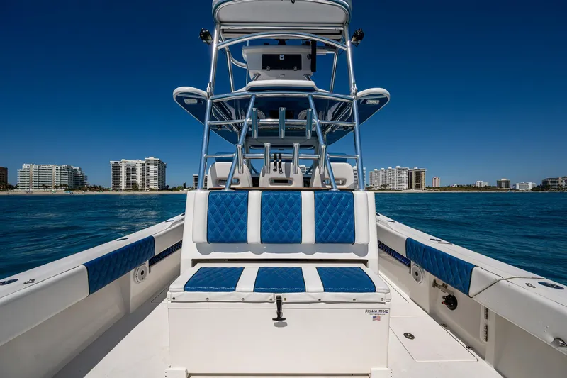  Yacht Photos Pics Front Runner 39 boat, 2020 model, with blue seating, on water near city skyline.