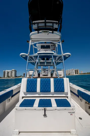  Yacht Photos Pics 2020 Front Runner 39 boat with blue seating, ocean view, and city skyline in the background.