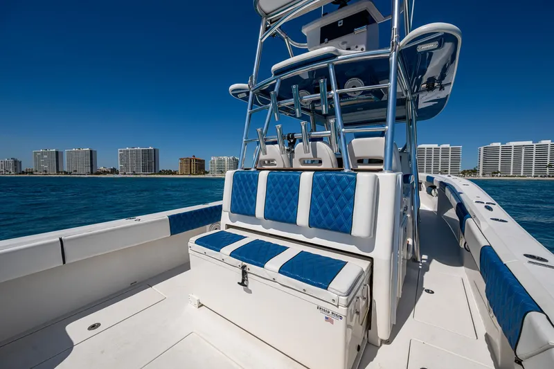  Yacht Photos Pics 2020 Front Runner 39 boat with blue seating, ocean view, and city skyline in the background.