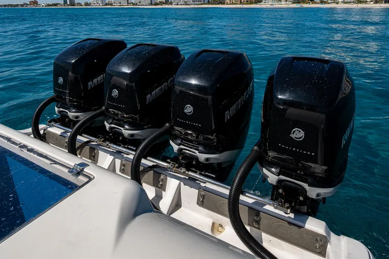  Yacht Photos Pics Four powerful outboard motors on a 2020 Front Runner 39 boat in clear blue water.