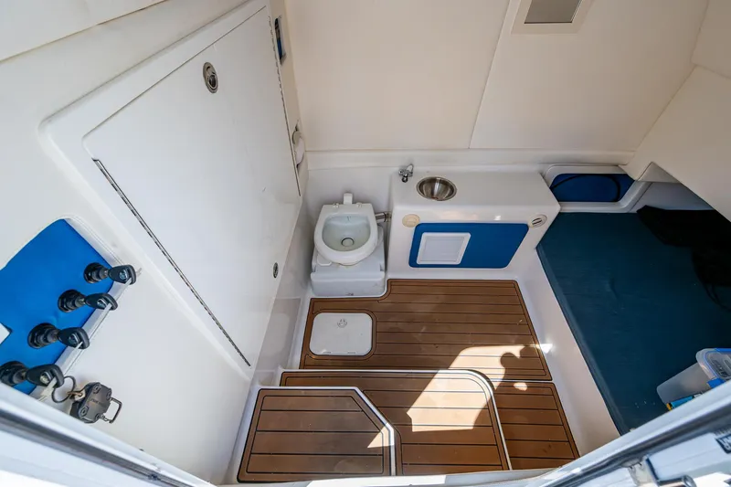  Yacht Photos Pics Interior of 2020 Front Runner 39 boat bathroom with wooden flooring and compact design.