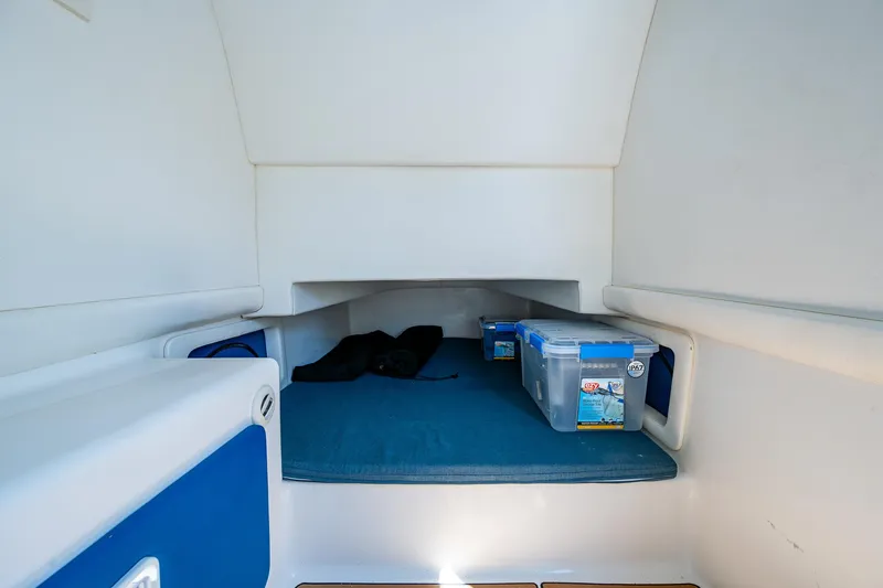  Yacht Photos Pics Interior cabin of 2020 Front Runner 39 boat with storage containers and blue bedding.