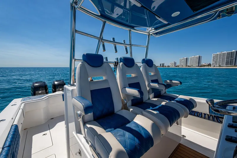  Yacht Photos Pics Luxury seating on a 2020 Front Runner 39 boat, with ocean and city skyline backdrop.
