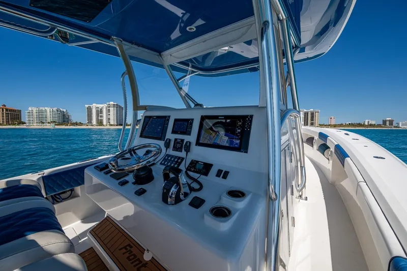  Yacht Photos Pics Cockpit view of 2020 Front Runner 39 boat with modern navigation equipment, ocean backdrop.