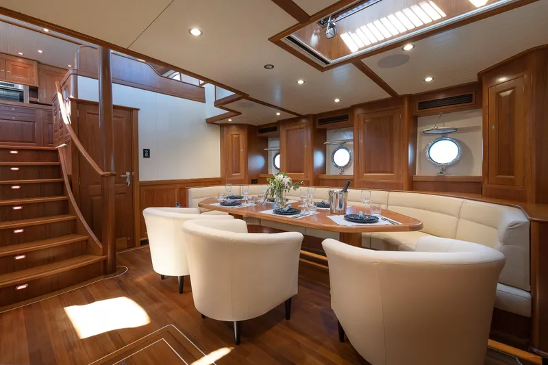 Melody Yacht Photos Pics Luxurious 2022 Ridas Custom Yacht interior with elegant dining area and wooden finishes.