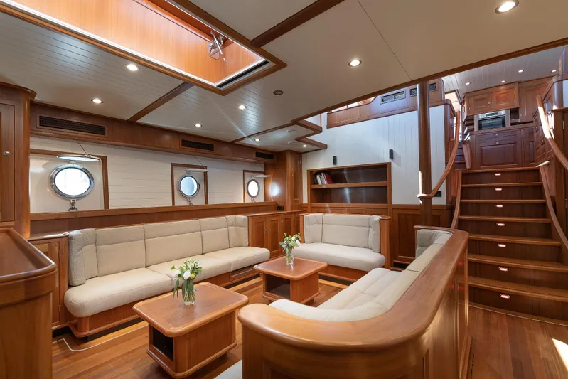 Melody Yacht Photos Pics Luxurious interior of 2022 Ridas Custom Yacht with elegant wood finish and plush seating.