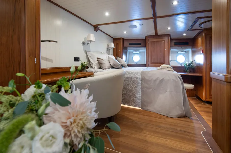 Melody Yacht Photos Pics Luxurious 2022 Ridas Custom Yacht bedroom with elegant wood finish and floral decor.