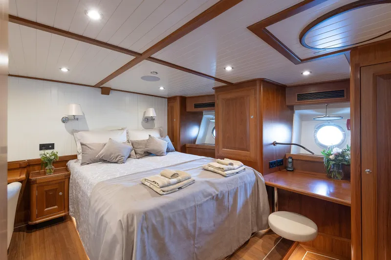 Melody Yacht Photos Pics Luxurious 2022 Ridas Custom Yacht bedroom with elegant wood finish and cozy bedding.