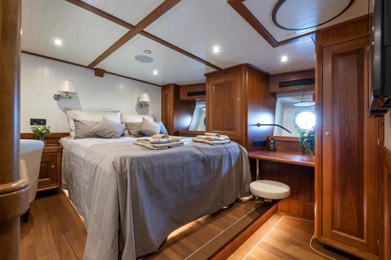 Melody Yacht Photos Pics Luxurious 2022 Ridas Custom Yacht bedroom with elegant wood paneling and cozy bedding.