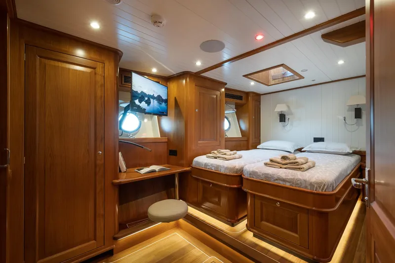 Melody Yacht Photos Pics Luxurious 2022 Ridas Custom Yacht cabin with twin beds, wooden interior, and modern amenities.